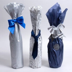 Wine bottles wrapped with tissue paper and tied with ribbon