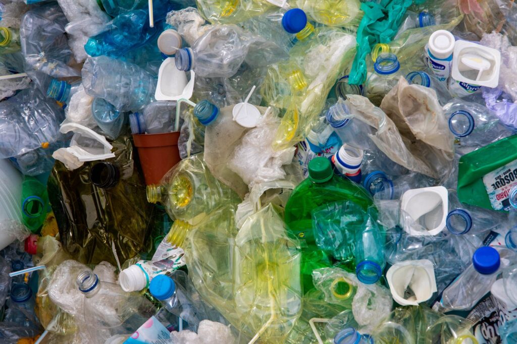 A pile of plastic trash including plastic bags and water bottles.