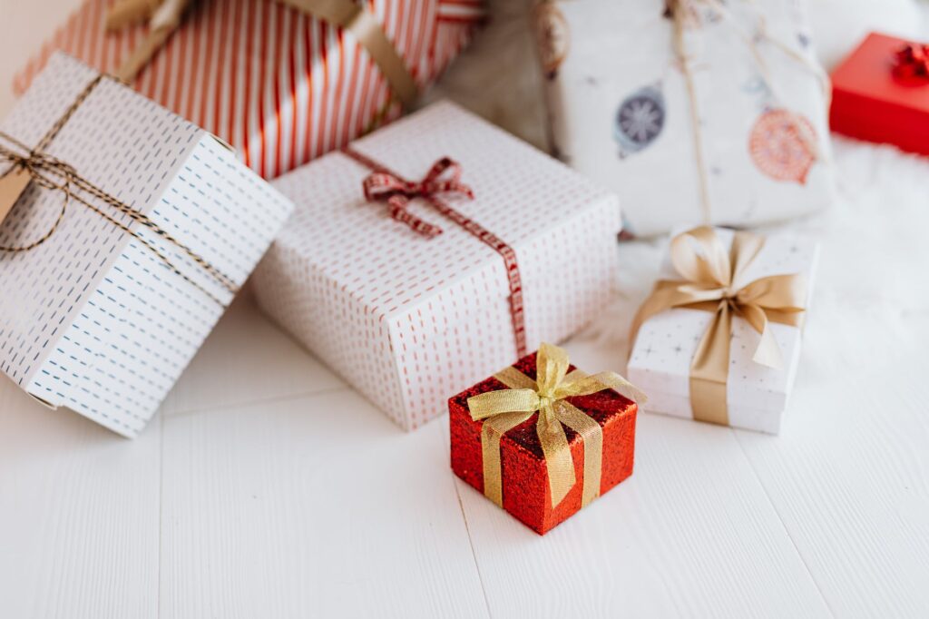 A group of gifts wrapped with ribbon and bows